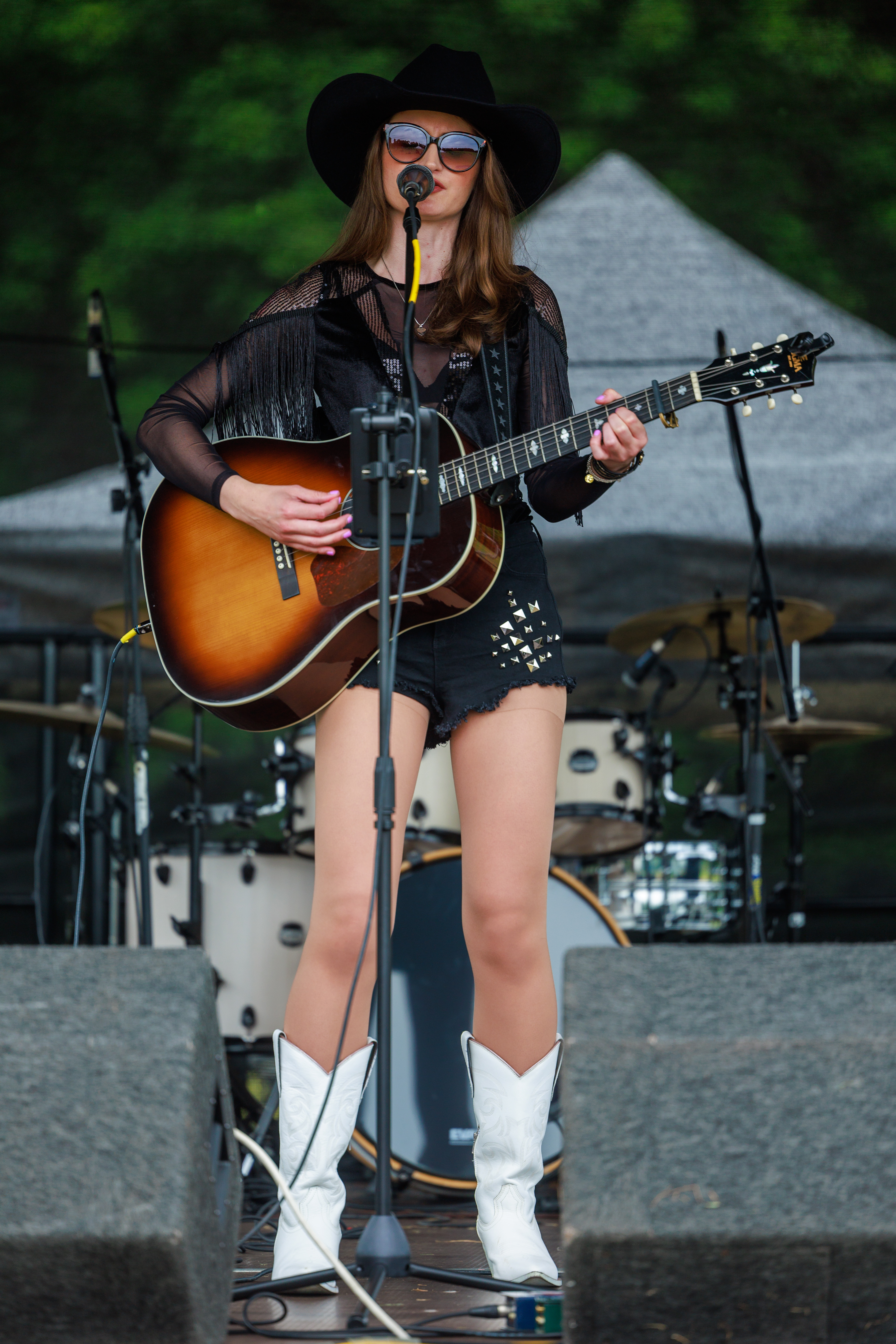 Hannah with guitar performing on stage