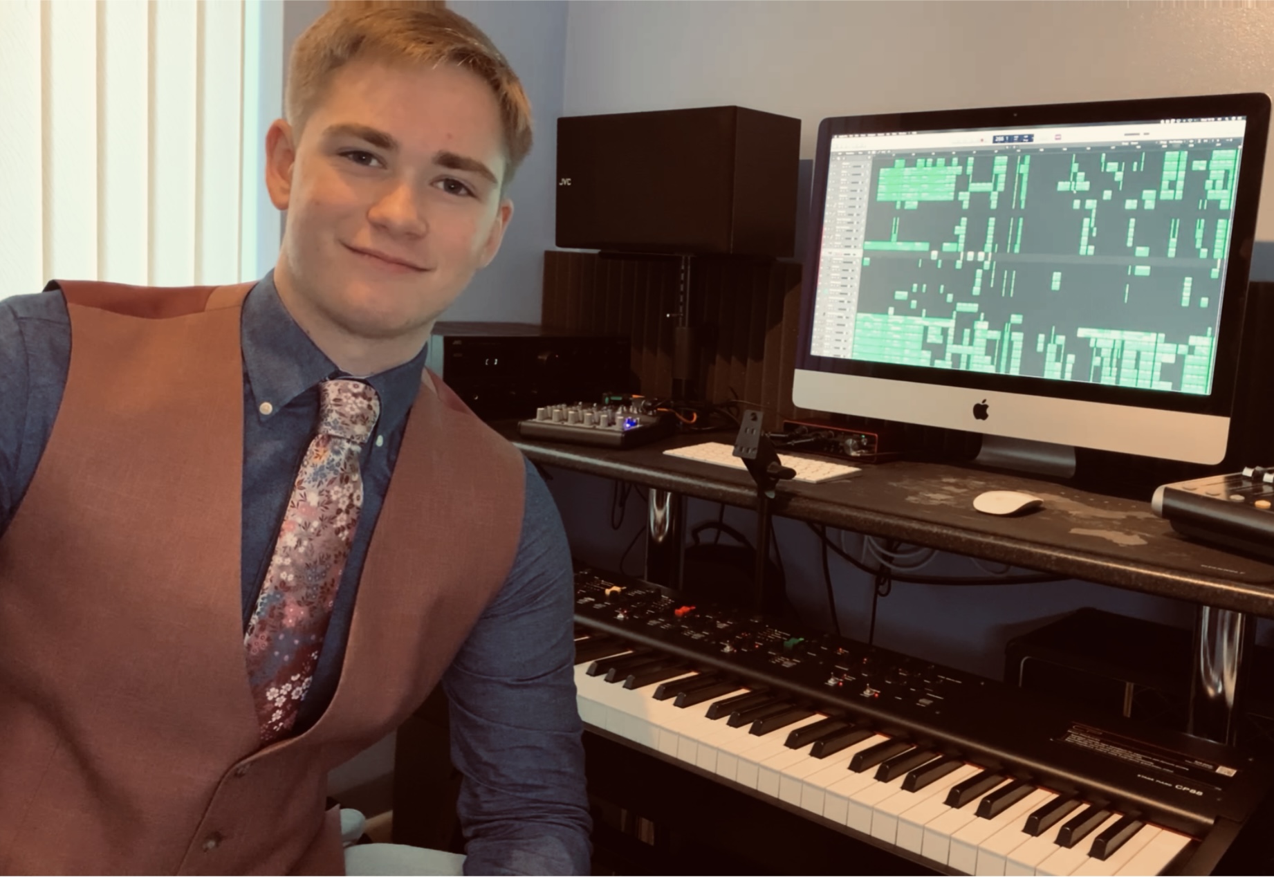 Joe standing by his keyboard.